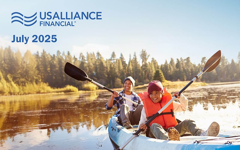 A father and son kayaking on a lake with USALLIANCE Financial logo and the words "July 2025" on top.