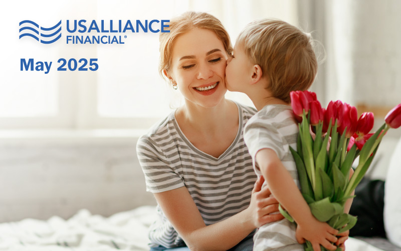A smiling woman being kissed on the cheek by a young boy holding red tulips, with text and a logo in the corner.